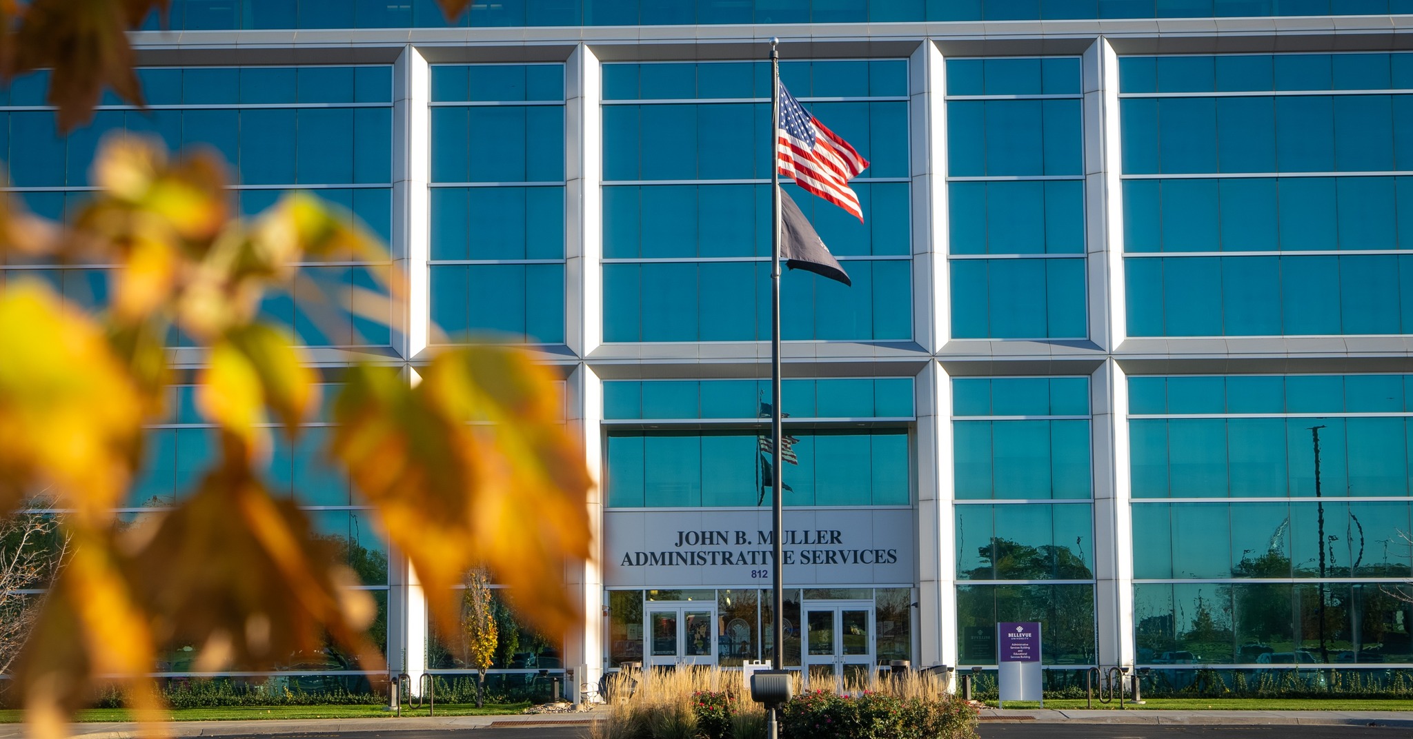 building with fall leaves in front