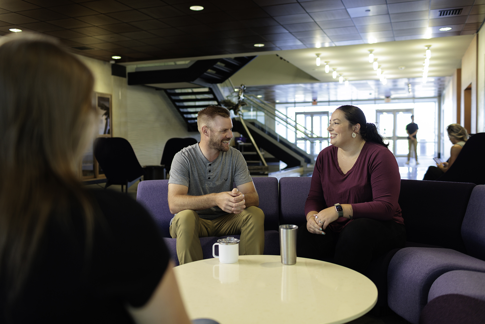 Two students sitting in lobby talking