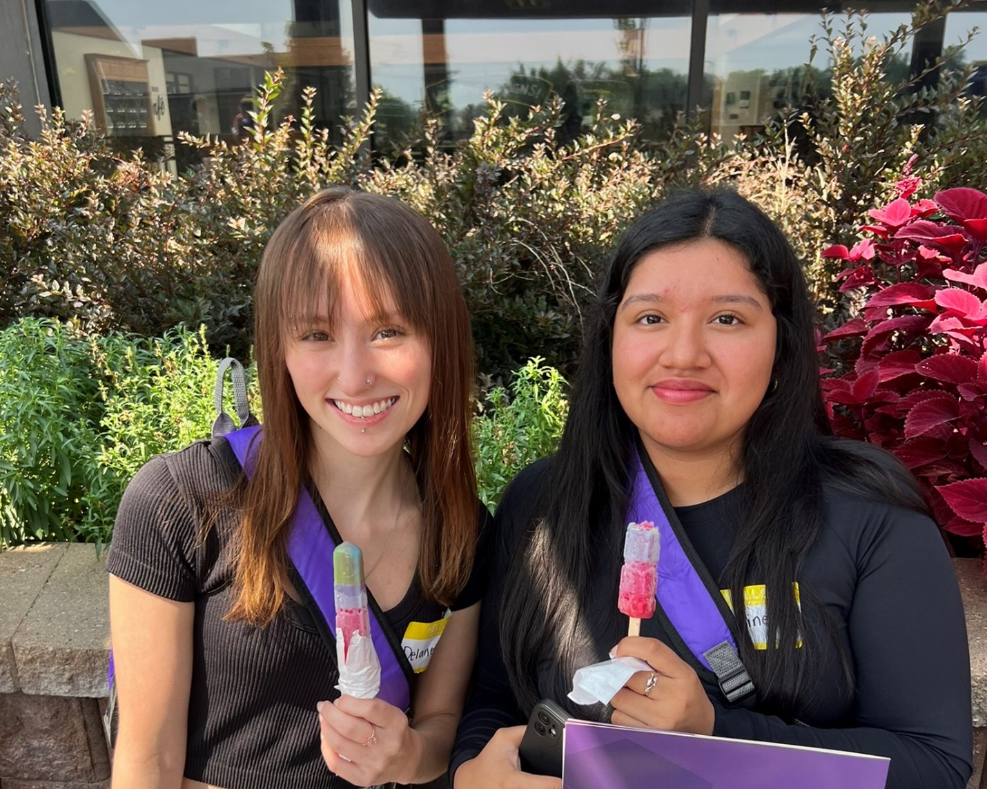 Two females holding popsicles