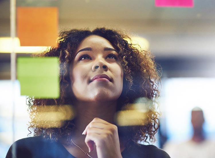 Woman with curly hair gazing up