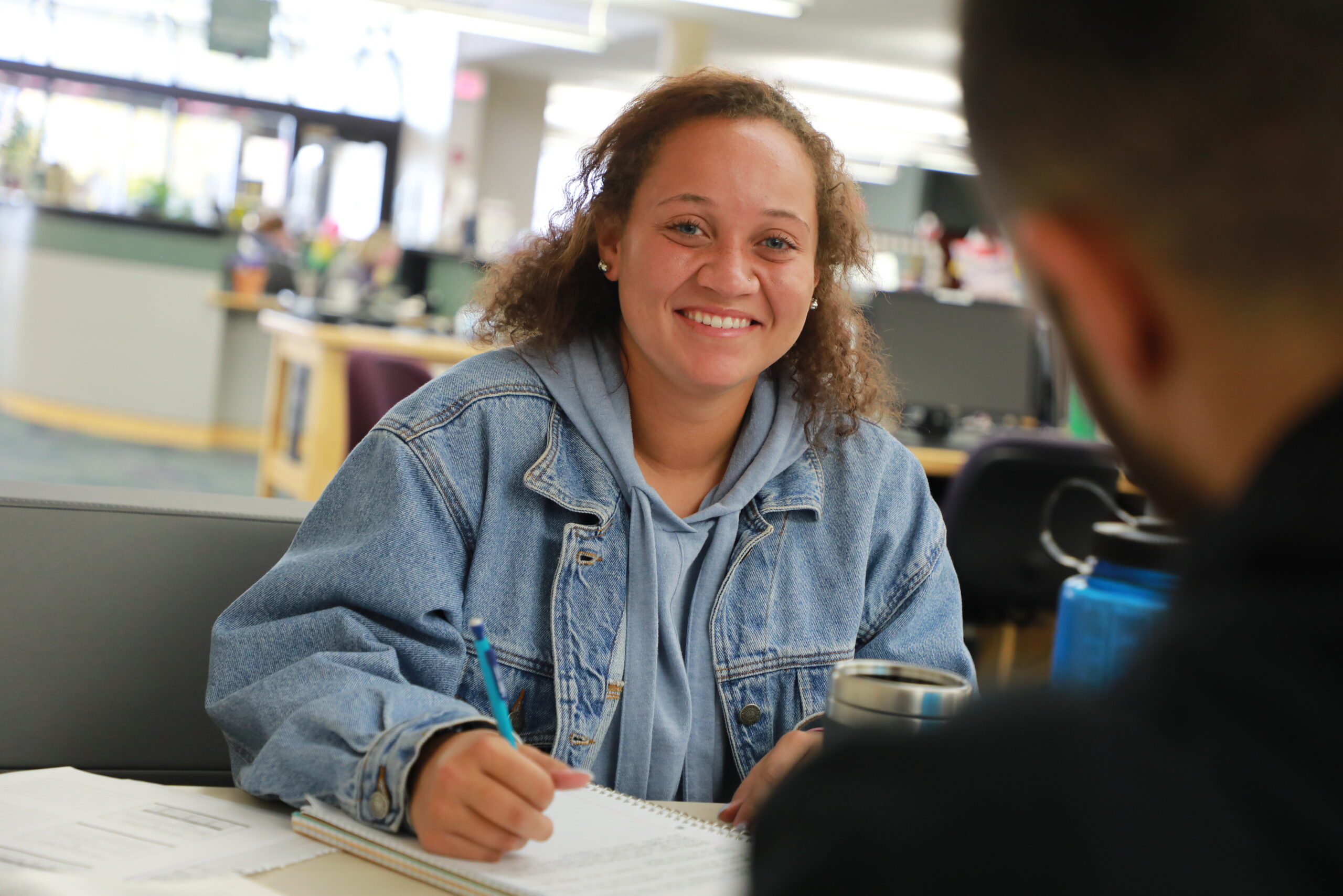student smiling in library