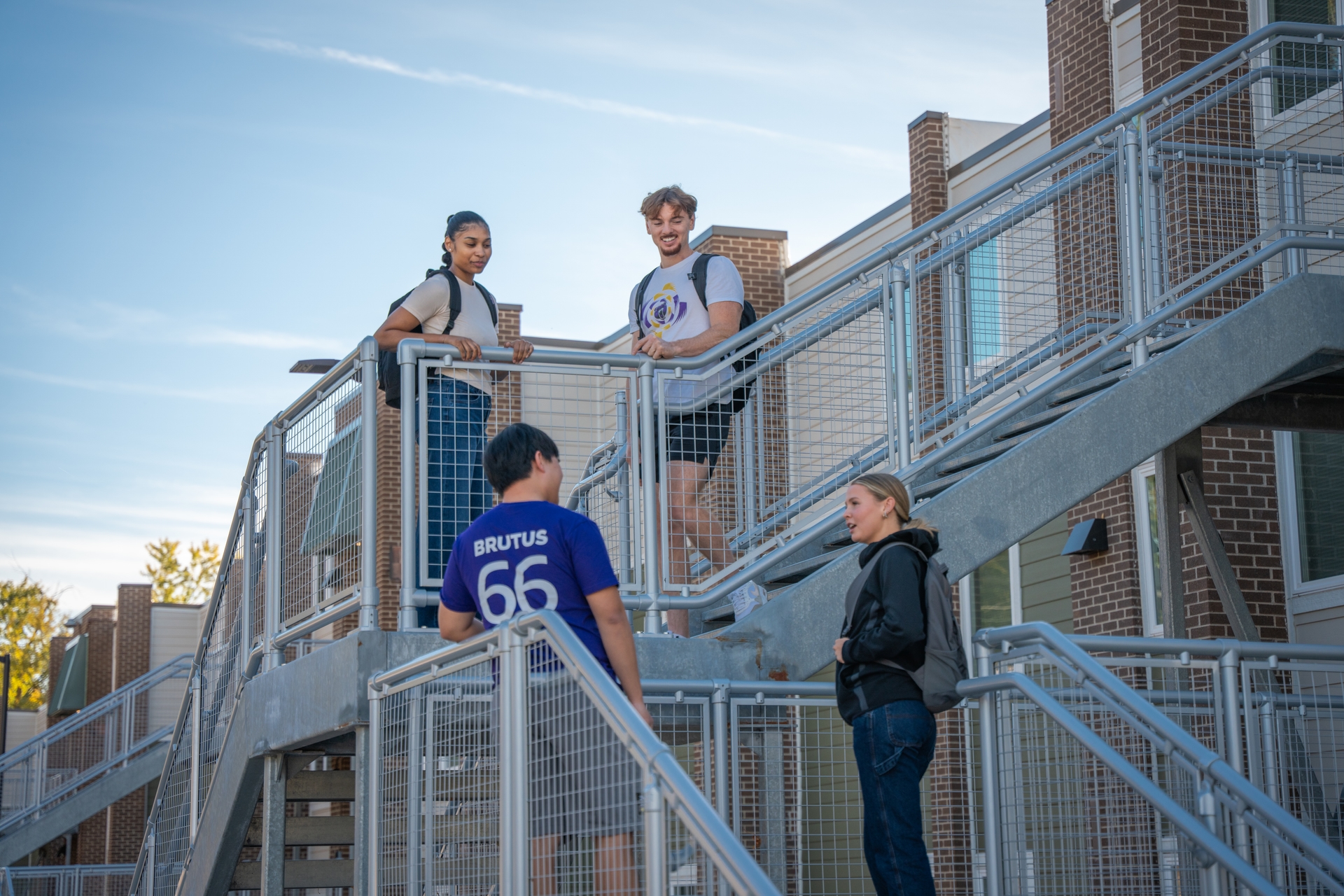 Student on steps of apartment building
