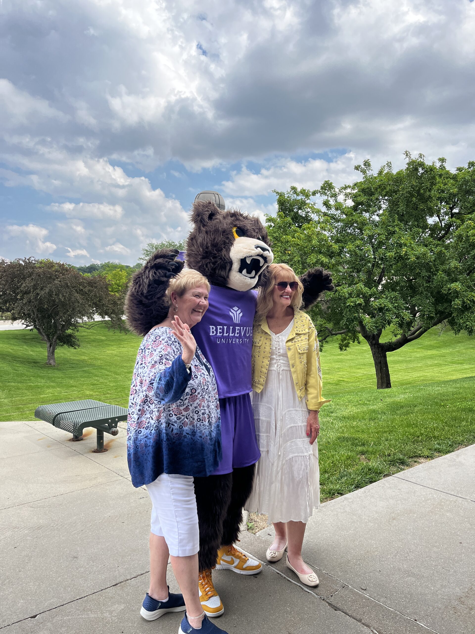 Brutus the Bruin mascot poses for photo with open house attendees.