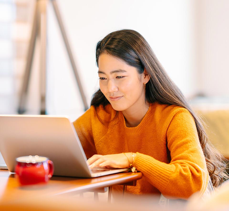 Girl typing on a laptop.