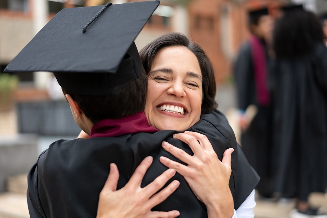 mother hugging graduate