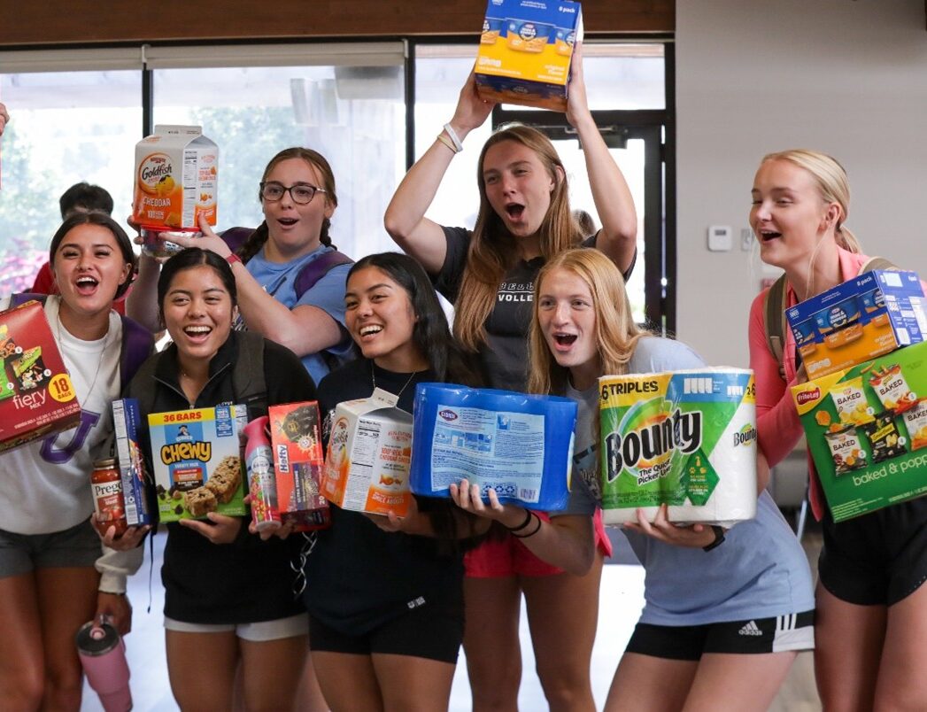 Group of girls holding grocery supplies