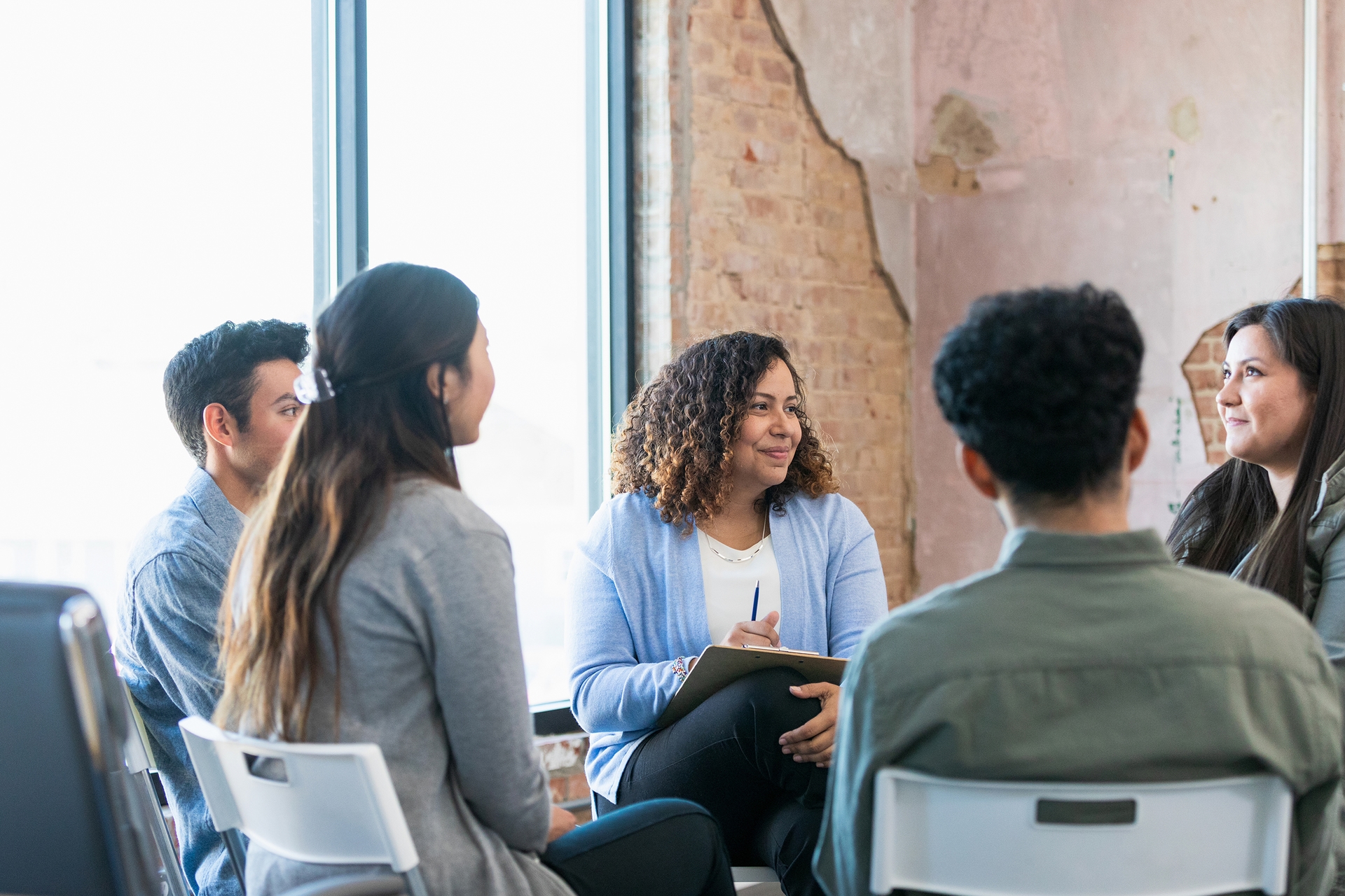 women sitting in circle meeting