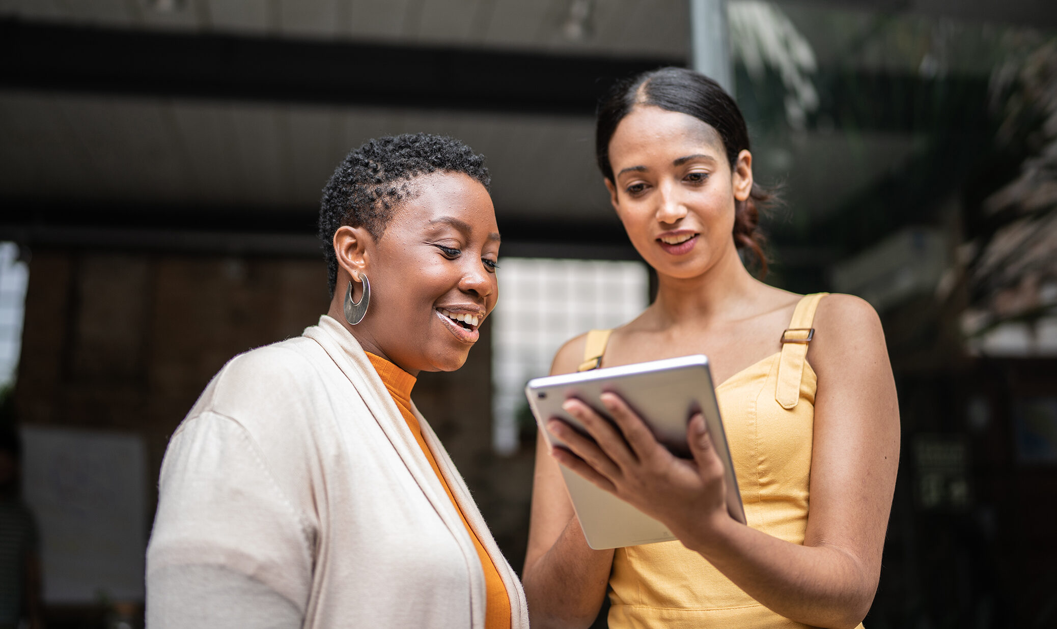 two women looking at ipad