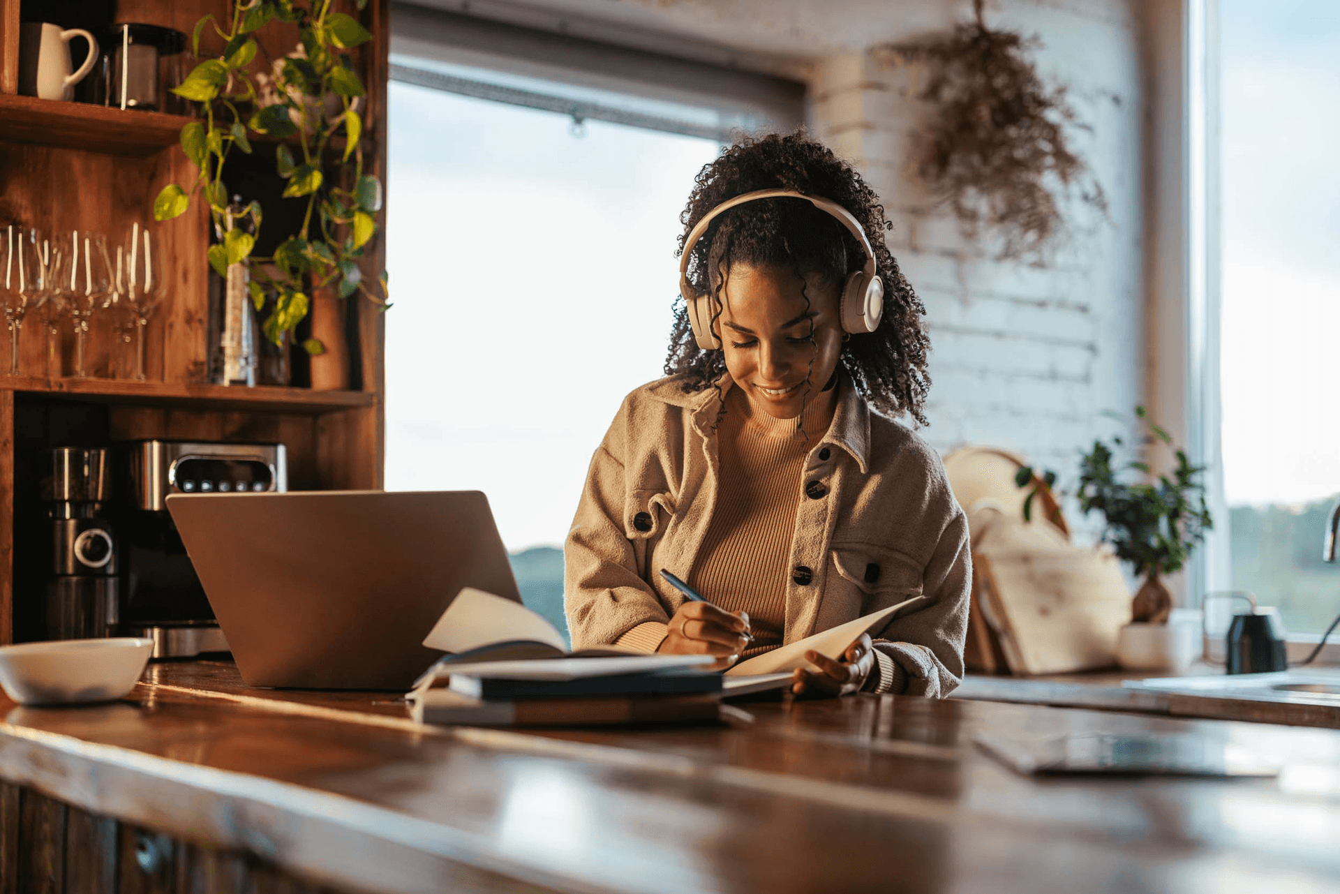 female with headphones working at desk