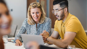 Man and woman looking at laptop